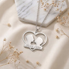 Pendentif couple en acier inoxydable posé à plat, date gravée sous un cœur