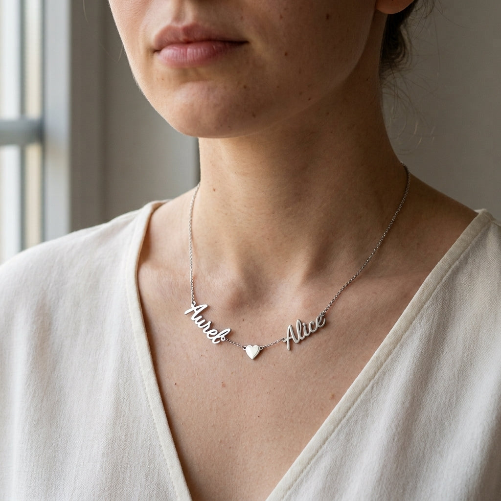 Collier en acier inoxydable à deux prénoms et un cœur porté au cou
